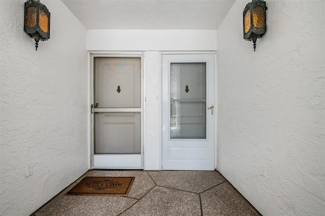 entrance to property with stucco siding