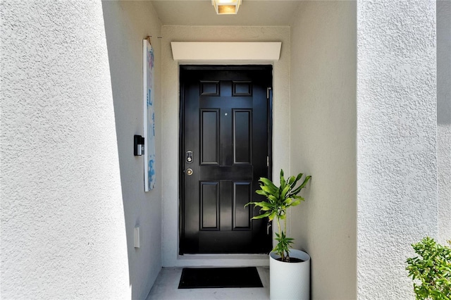 property entrance featuring stucco siding