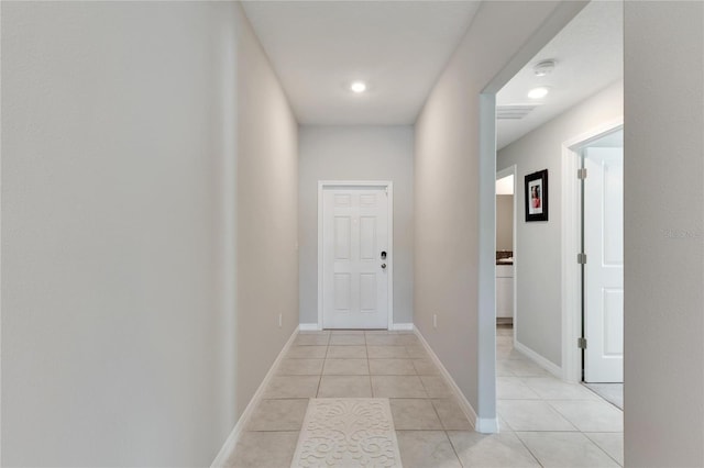 corridor with light tile patterned flooring