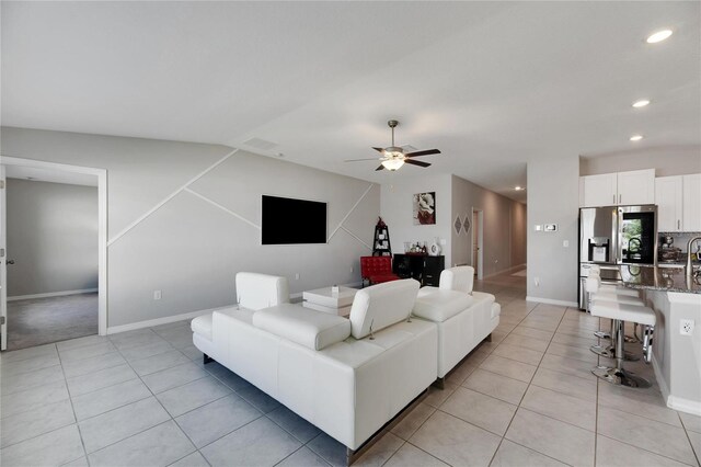 tiled living room with ceiling fan