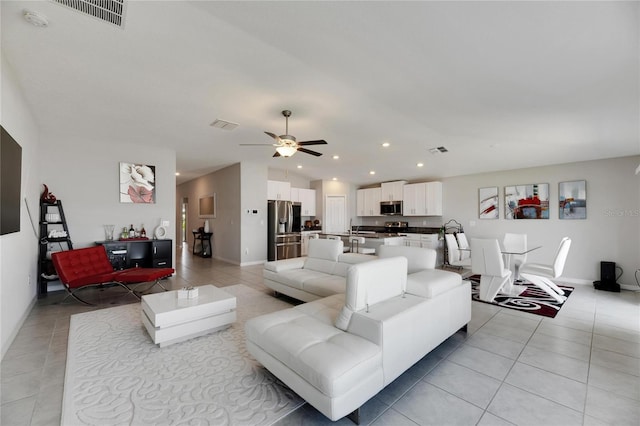 living room with ceiling fan and light tile patterned flooring