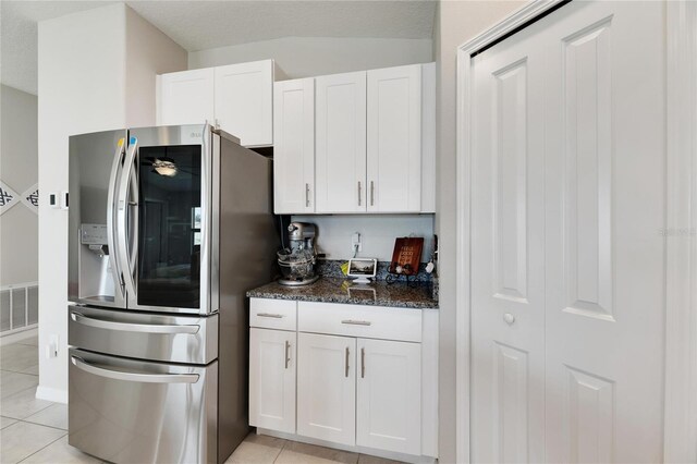 kitchen featuring white cabinetry, light tile patterned floors, and stainless steel fridge with ice dispenser