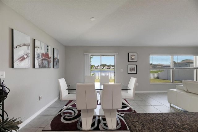 dining area featuring a textured ceiling and tile patterned floors