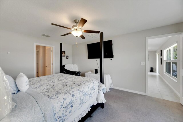 bedroom with ceiling fan and light carpet