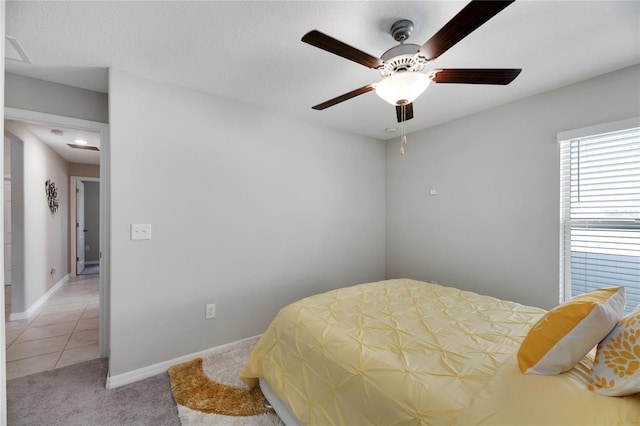 carpeted bedroom with ceiling fan and a textured ceiling