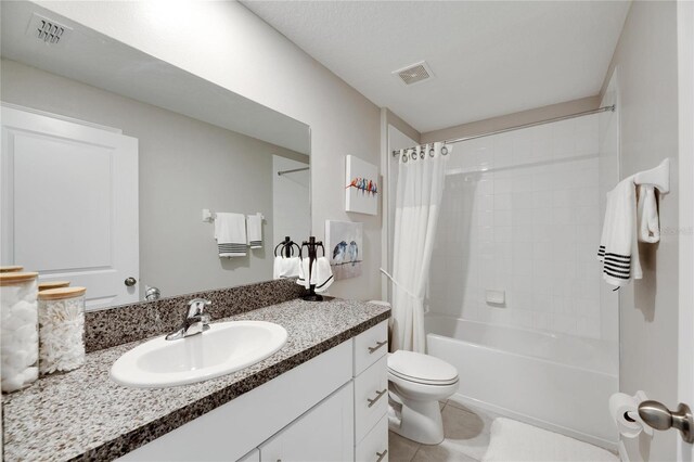 full bathroom featuring toilet, tile patterned flooring, vanity, a textured ceiling, and shower / bathtub combination with curtain