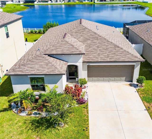 view of front of house with a water view, a garage, and a front lawn