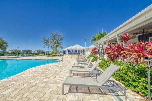 view of pool featuring ceiling fan and a patio