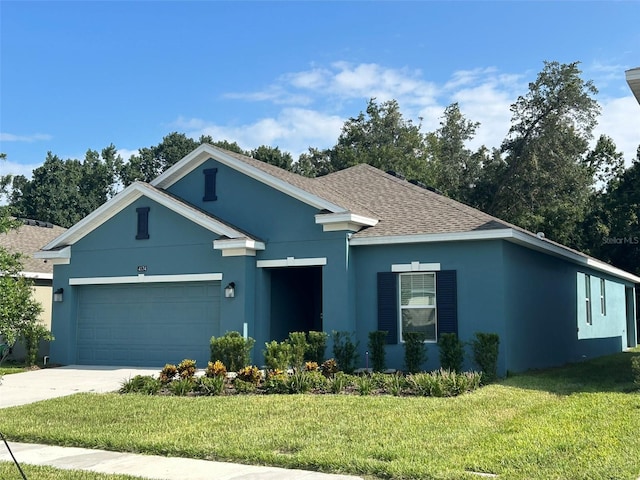 view of front of property with a garage and a front lawn