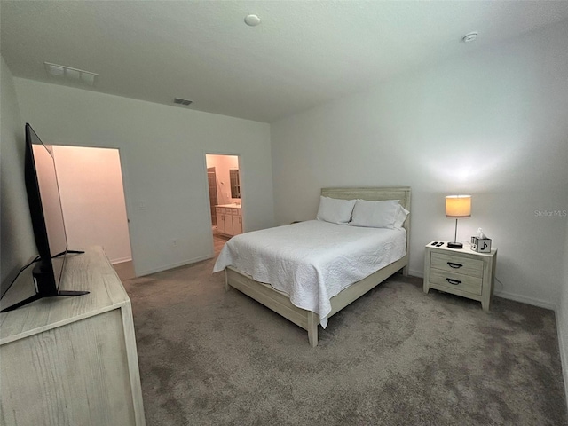 bedroom with carpet flooring and connected bathroom