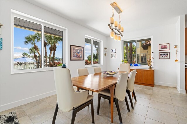 dining area with an inviting chandelier and light tile patterned floors