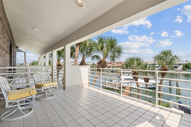 view of patio / terrace with a balcony and a water view