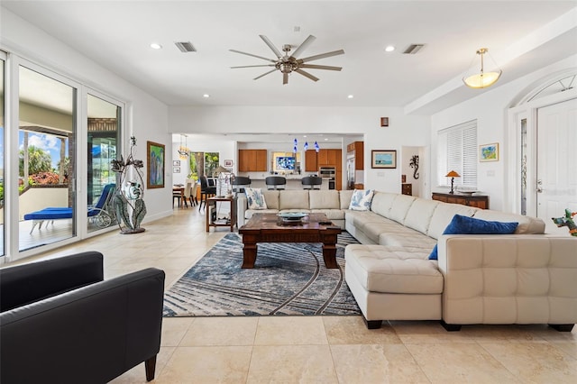 tiled living room with ceiling fan