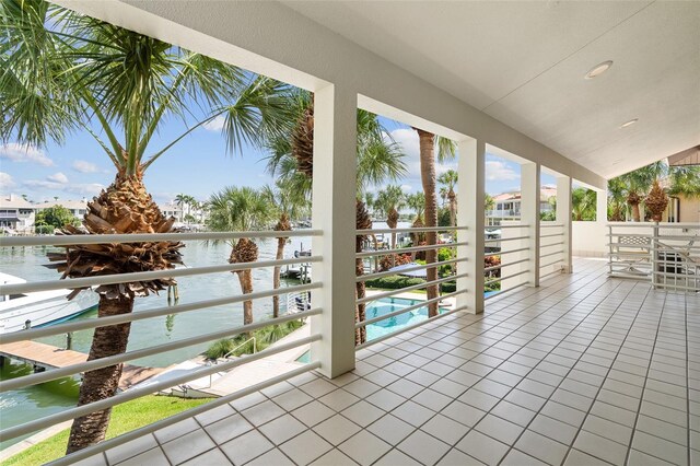 view of patio with a balcony and a water view