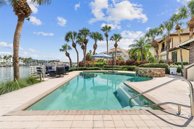 view of swimming pool with a water view