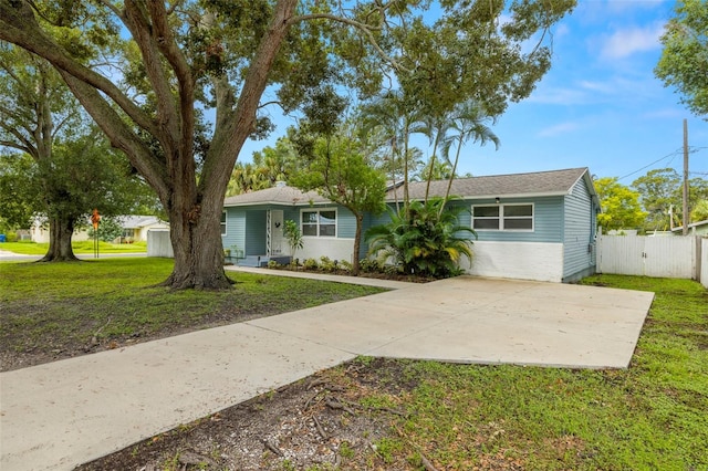 ranch-style home with a front lawn