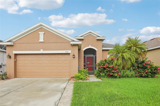 view of front of property with a garage and a front lawn