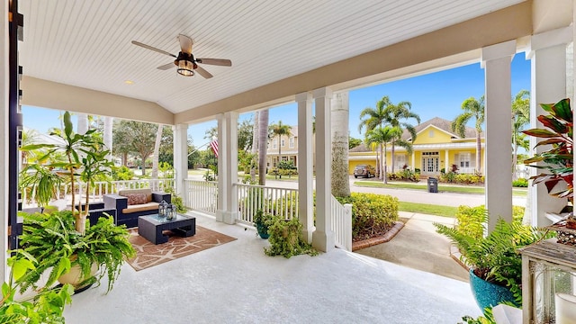 sunroom / solarium featuring ceiling fan, vaulted ceiling, and a wealth of natural light