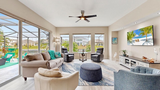 living room featuring ceiling fan and light wood-type flooring