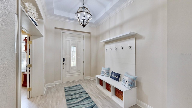 mudroom featuring light wood-style floors, crown molding, a chandelier, baseboards, and a raised ceiling