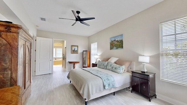 bedroom with light wood-style flooring, baseboards, and ceiling fan