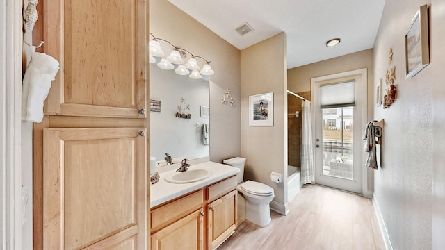bathroom featuring toilet, vanity, shower / tub combo with curtain, baseboards, and wood finished floors