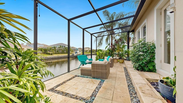 sunroom featuring a water view