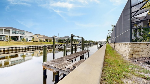 dock area with a water view, a residential view, and a lanai