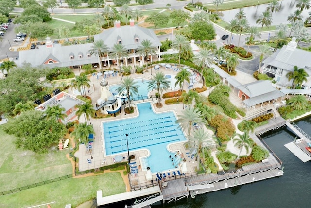 aerial view of a pool area and a large body of water