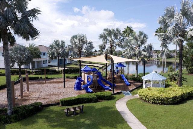 community jungle gym with a lawn and a water view