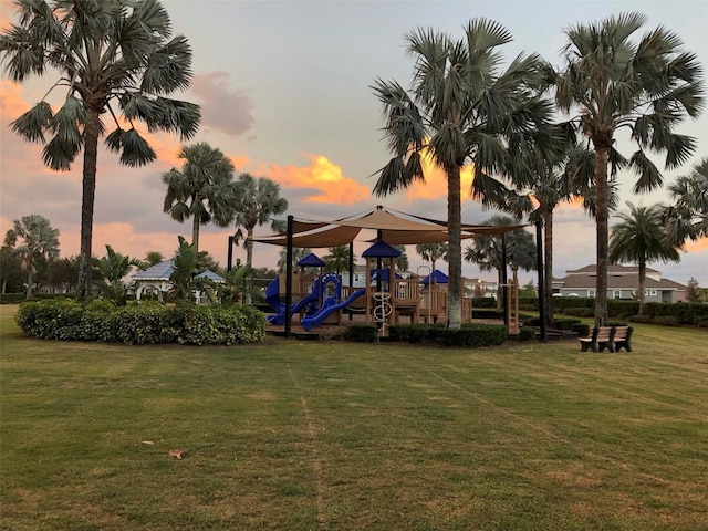 playground at dusk featuring a yard