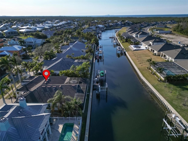 aerial perspective of suburban area with a nearby body of water
