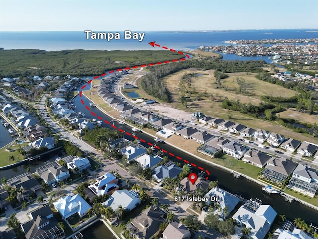aerial view of property's location featuring a nearby body of water and nearby suburban area