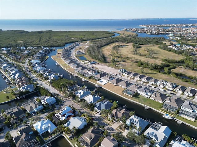 view of property location with a large body of water and nearby suburban area