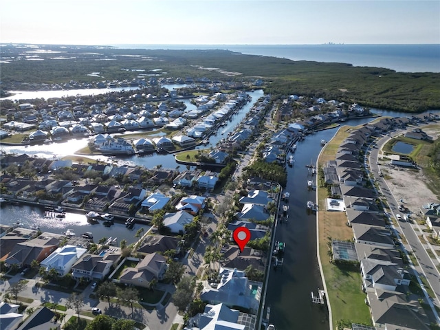 aerial view of property's location with a nearby body of water and nearby suburban area