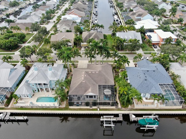 aerial view of residential area featuring a large body of water and a pool area