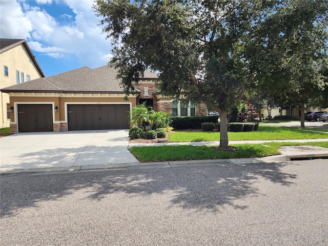 view of front of property with a garage and a front lawn