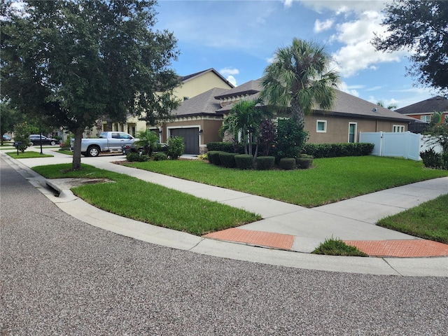 view of front facade with a front lawn and a garage