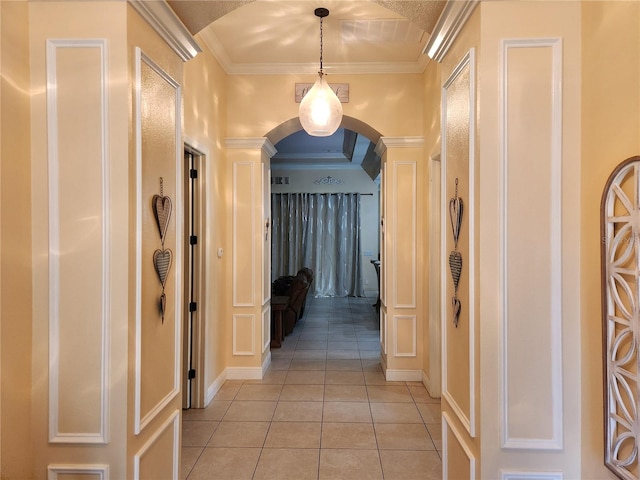 corridor with ornamental molding and light tile patterned floors