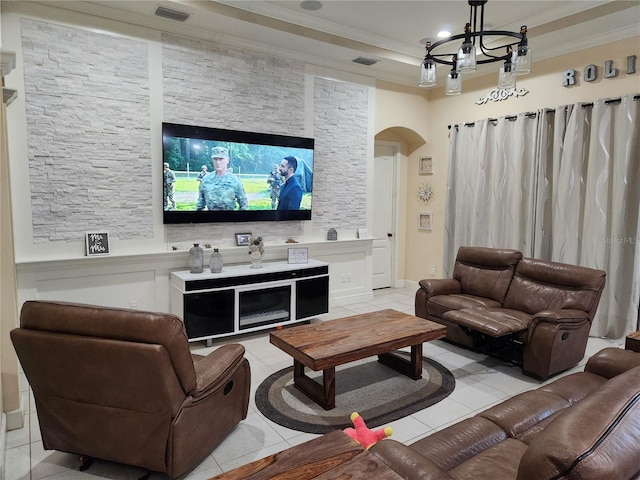 tiled living room featuring ornamental molding and a notable chandelier