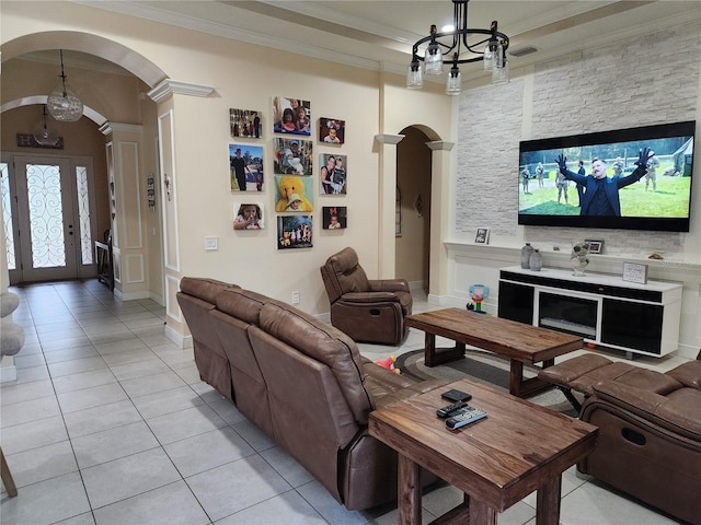 living room with crown molding, an inviting chandelier, and light tile patterned floors