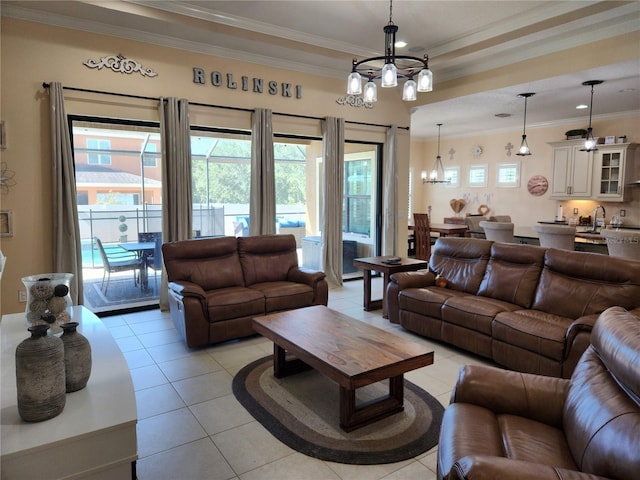 living room featuring a wealth of natural light, a chandelier, and ornamental molding