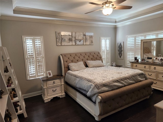 bedroom featuring crown molding, ceiling fan, a tray ceiling, and dark hardwood / wood-style flooring