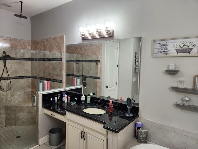 bathroom with tile patterned flooring, vanity, and a shower with shower door