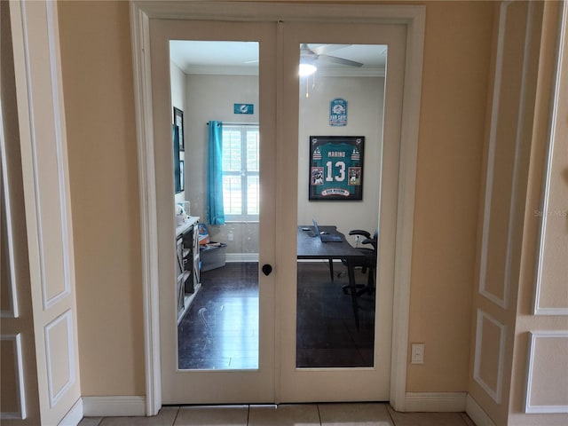 hallway featuring crown molding, french doors, and light tile patterned flooring