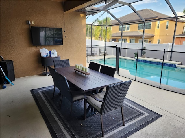 view of swimming pool featuring a patio area and glass enclosure