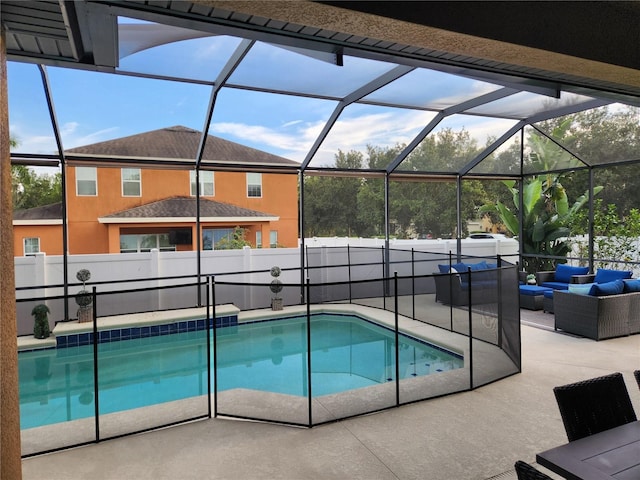 view of swimming pool with an outdoor living space, a lanai, and a patio