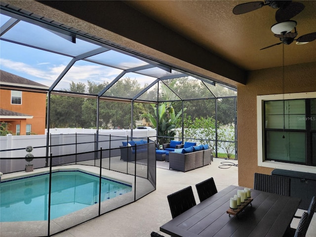 view of swimming pool featuring a lanai, an outdoor hangout area, a patio area, and ceiling fan