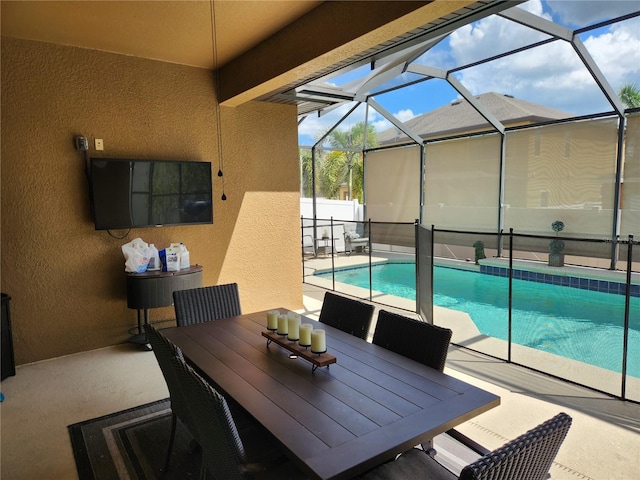 view of pool with a patio and glass enclosure