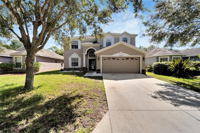 view of front of home with a garage and a front lawn